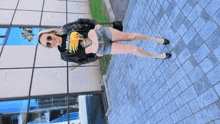 a woman wearing a metallica shirt and shorts