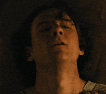 a close up of a person 's face with a dark background
