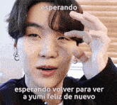 a close up of a person 's face with the words esperando volver para ver a yumi feliz de nuevo above it