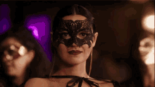 a woman wearing a black mask with red lips