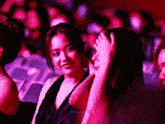 a woman in a black dress holds her hand to her head in front of a sign that says filmance