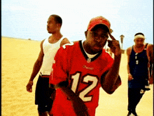 a man wearing a red jersey with the number 12