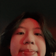 a close up of a person 's face with a red background