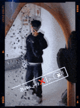 a man taking a picture of himself in front of a mirror with the words baba written on it
