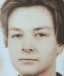 a close up of a person 's face with a serious look on his face