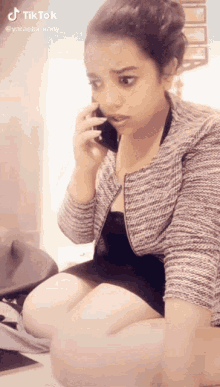 a girl is talking on a cell phone with the hashtag tiktok