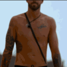 a man without a shirt has a tattoo on his chest that says " jesus "