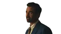 a man in a suit and tie is smiling