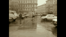 a black and white photo of a parking lot with cars parked in it