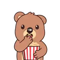 a teddy bear is holding a striped bucket of popcorn in its paws