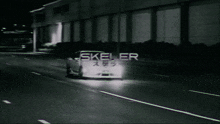 a black and white photo of a car with skeller written on the front