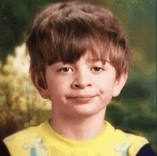 a young boy with brown hair is wearing a yellow shirt with spongebob on it