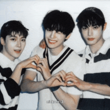three young men are making a heart shape with their hands and nickren : 3 is written below them