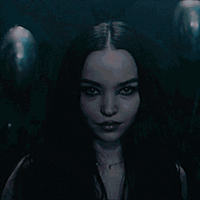 a close up of a woman 's face with dark hair