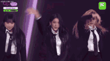 a woman in a suit and tie is dancing on stage .