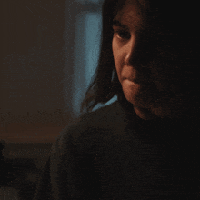 a close up of a person 's face in the dark