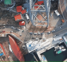 an aerial view of a city with a ferris wheel and boats