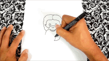 a person is drawing a picture of jesus with a black marker that says ' permanent marker ' on it