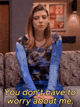 a woman sitting on a couch with the words " you don t have to worry about me "