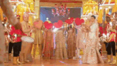 a group of people are standing in a room holding heart shaped balloons .