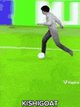 a man is kicking a soccer ball on a field with the words kishigoat written on the bottom .