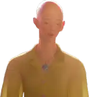 a bald man wearing a yellow shirt and a necklace with a heart pendant