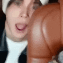 a close up of a person 's face with their tongue sticking out