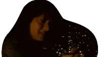 a woman is holding a string of lights in her hand