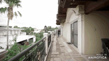 a woman stands on a balcony with the words made in animotica written on the bottom