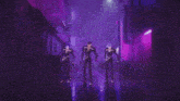 three anime characters are dancing in a dark alleyway .