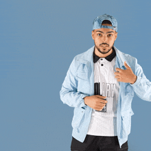 a man wearing a blue hat and a white shirt that says aldi on it
