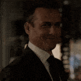 a close up of a man 's face with a suit and tie