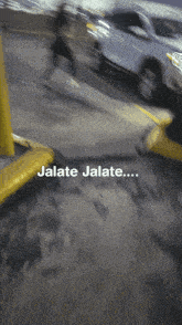 a blurry picture of a parking lot with jalate jalate written on the bottom