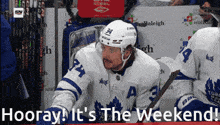 a hockey player with the number 34 on his jersey sits on the bench