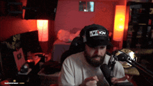 a man wearing a hat that says " owt now " on it
