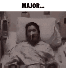a man is laying in a hospital bed with an oxygen mask on his face and the words major written above him