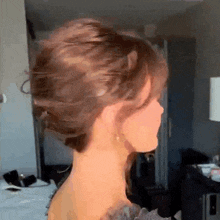 a woman 's hair is blowing in the wind behind her