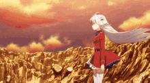 a girl with long white hair is standing on a rocky hill