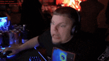 a man wearing headphones sits in front of a computer monitor