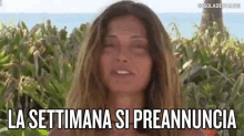 a woman with her eyes closed and the words la settimana si preannuncia on her face