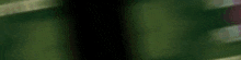 a blurred image of a person 's face with a purple and green background