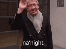 a man in a suit and scarf is waving his hand and the words na ' night are above him