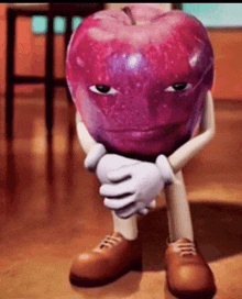 a cartoon apple with arms and legs is sitting on the floor with his hands on his chin .