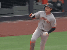 a baseball player wearing a san francisco jersey runs on the field