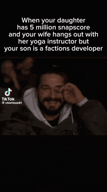 a man is covering his face with his hand while watching a movie ..