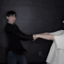 a blurry picture of two men standing next to each other in a room .