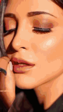 a close up of a woman getting her makeup done