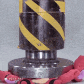 a stuffed animal is laying on top of a metal object with pika art written on it