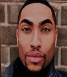 a close up of a man 's face with a pink lip