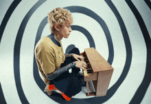 a man playing a piano in front of a spiral